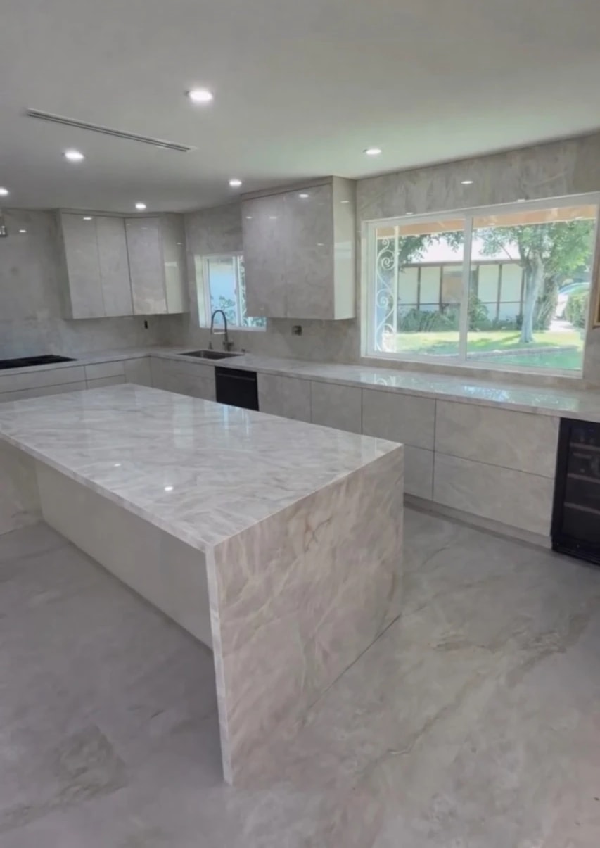 Granada Hills kitchen remodel: marble-look waterfall island, slab backsplash and high-gloss cabinetry
